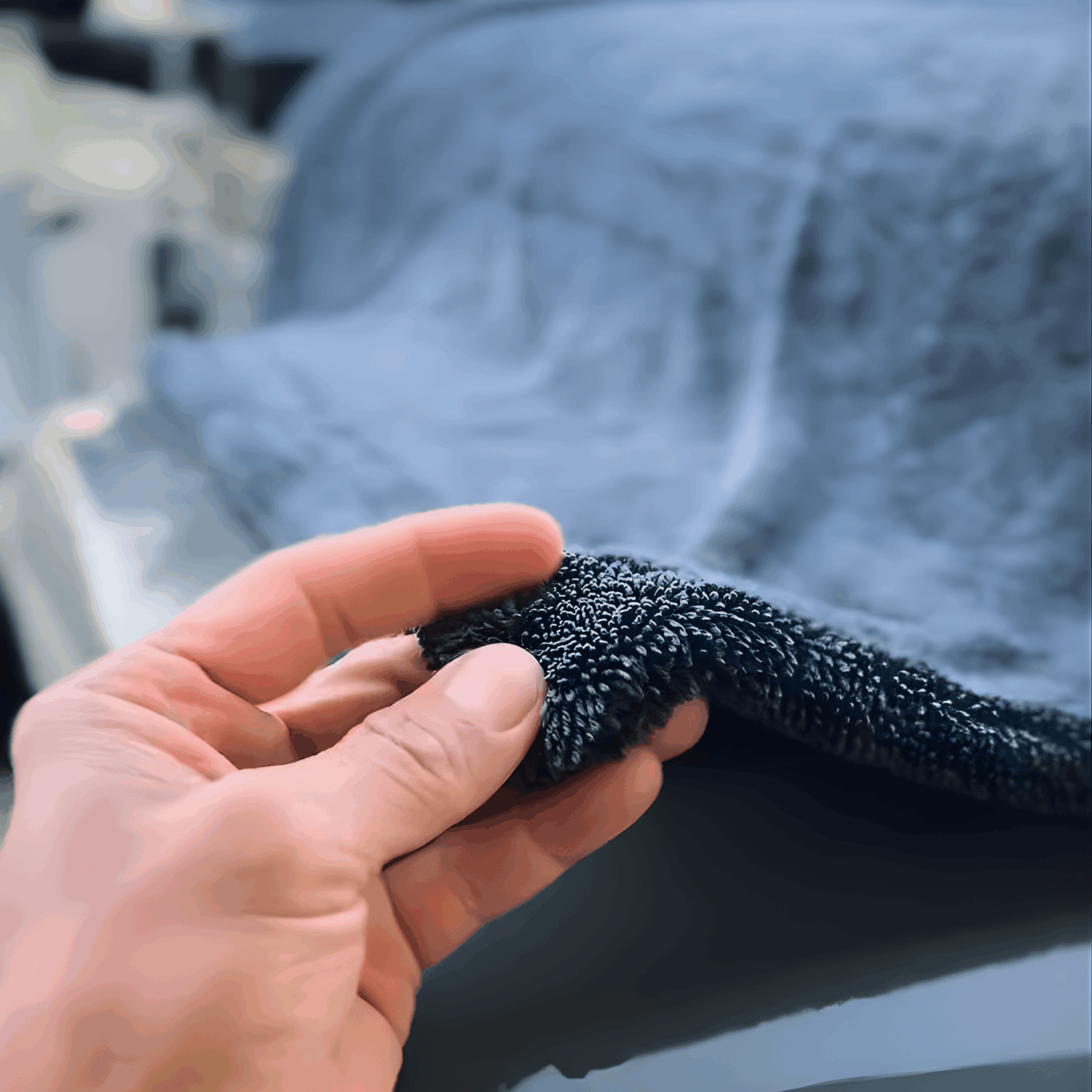 Close-up of a high-density 1300 GSM twisted loop car drying towel showing the deep microfiber pile.